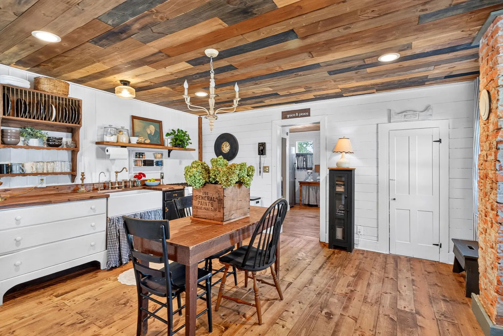 Farmhouse kitchen and dining area under a reclaimed wood ceiling