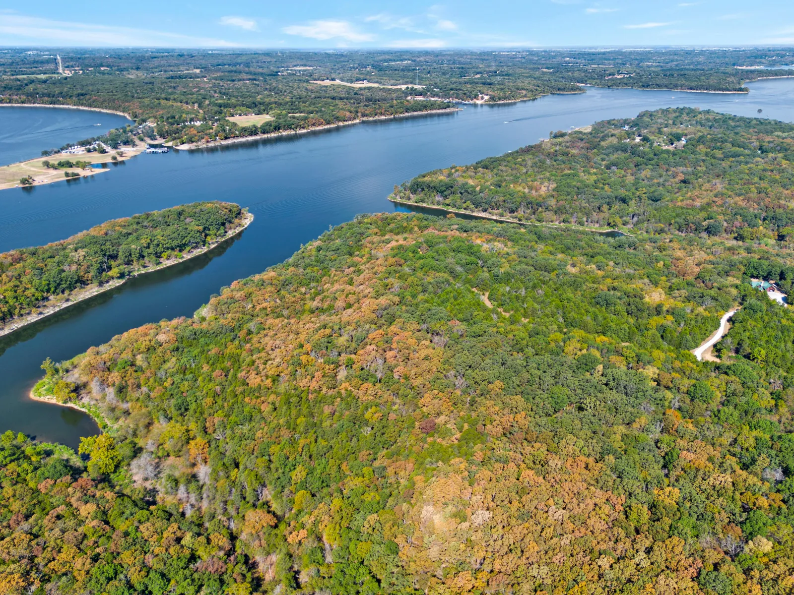 Aerial view of forested lakeside land between two coves