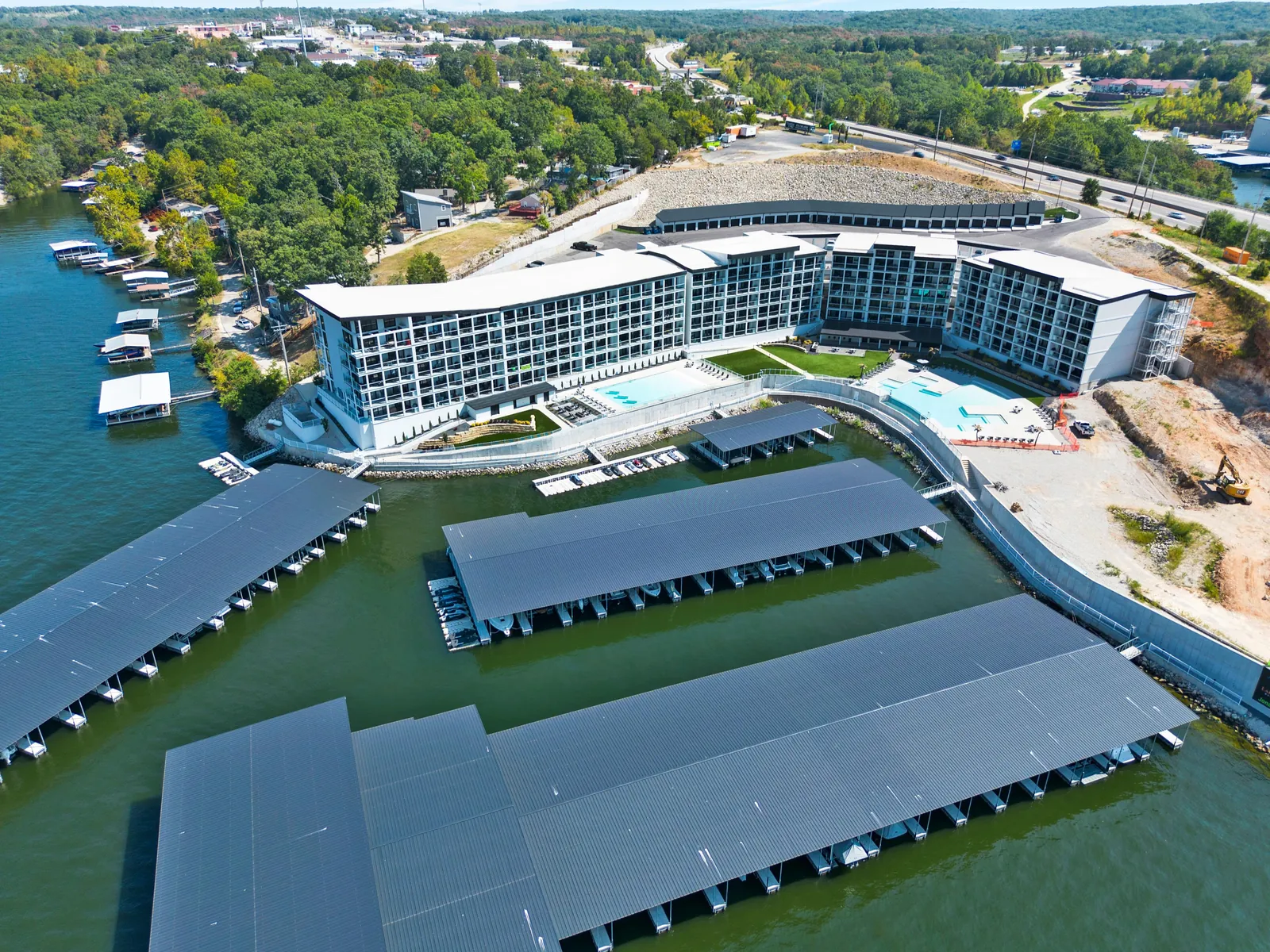 Aerial view of a lakefront resort with covered boat docks
